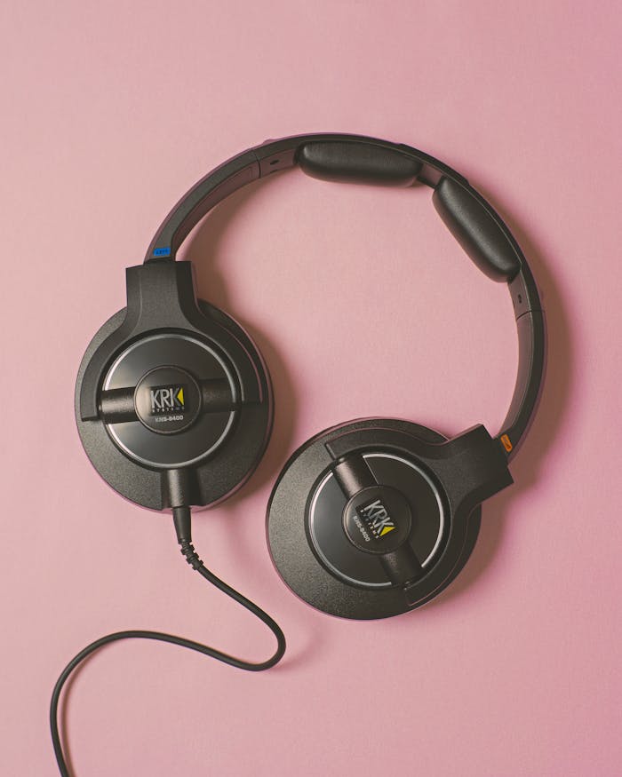 Close-up of KRK headphones on a pink background, perfect for music and audio technology themes.